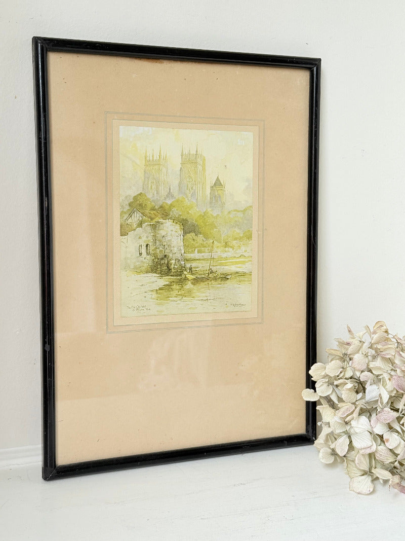 framed print of york minster and city walls in black frame, photographed on white surface