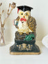 vintage hand painted cast iron owl doorstop with mortarboard and bow tie on white surface