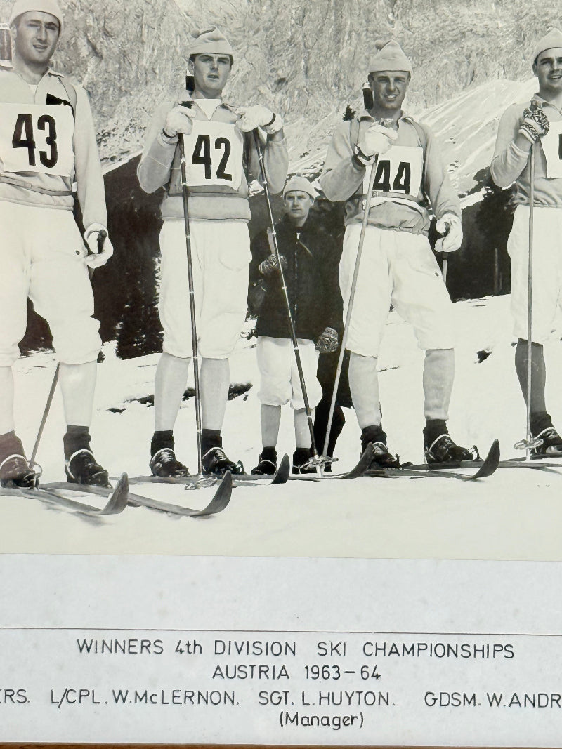 Vintage black and white framed photograph of the 1st Battalion Irish Guards Ski Team, 1963–64, posed in full ski gear against the Austrian Alps.