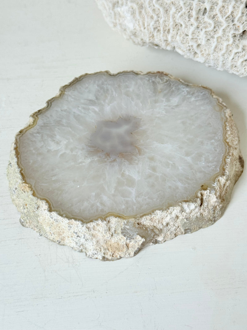 Vintage natural agate stone soap dish in grey and white, photographed on a white surface.