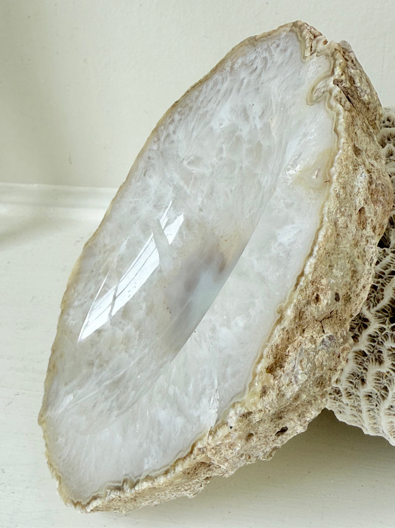 Vintage natural agate stone soap dish in grey and white, photographed on a white surface.