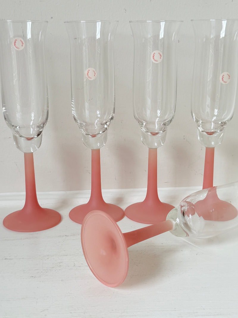 Set of five 1980s frosted pink tulip champagne flutes from the Candlelight range, photographed on a white surface