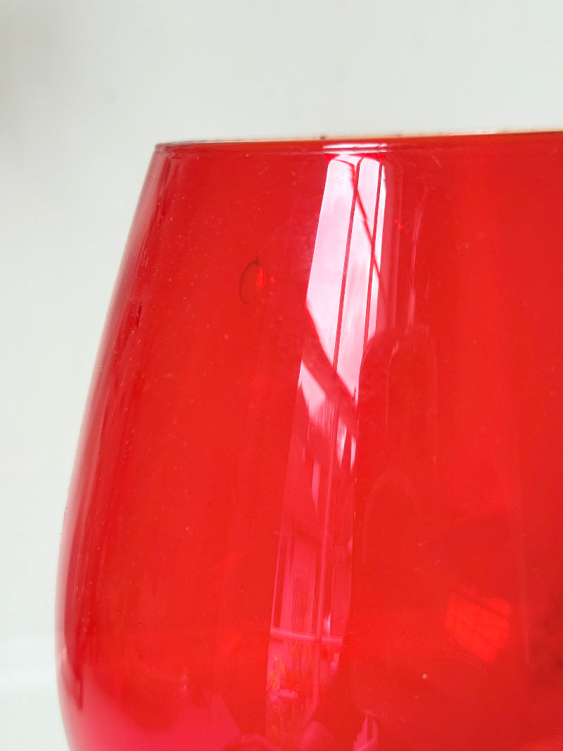 Large retro red glass brandy glass displayed on a white background.