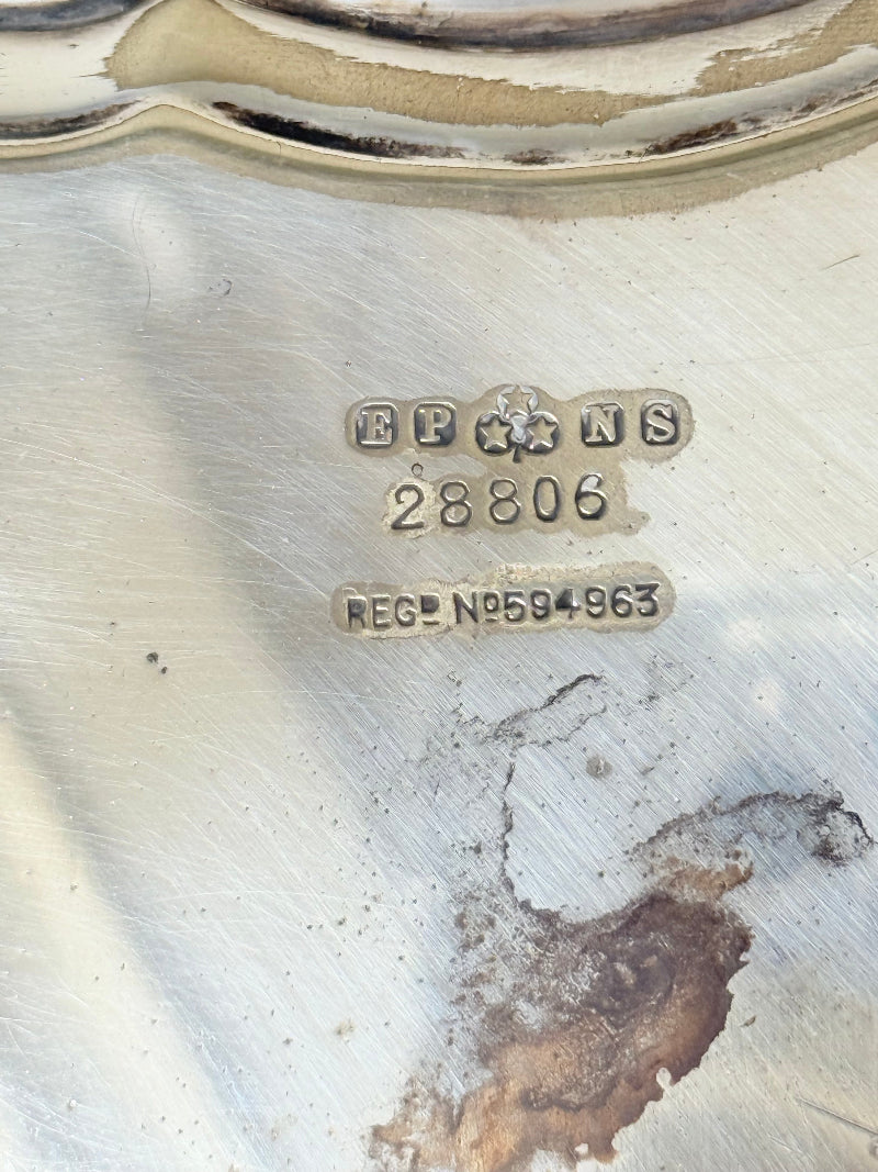 Vintage silver plate tray with scalloped edge and footed base, photographed on a white surface
