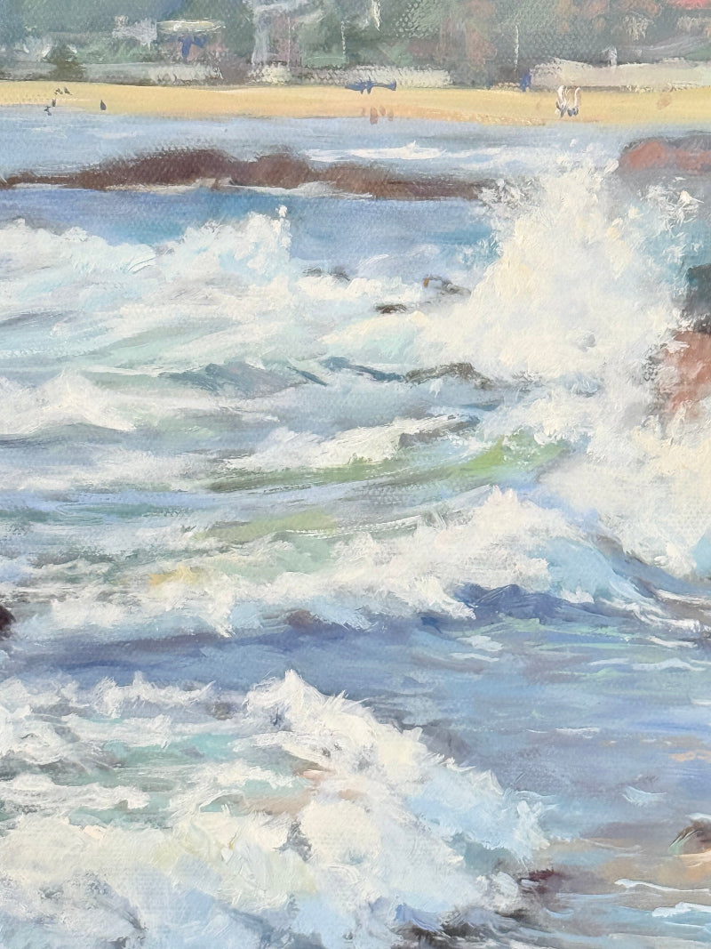 Original oil painting of waves crashing against rocks, signed seascape in slate blue wooden frame on white surface