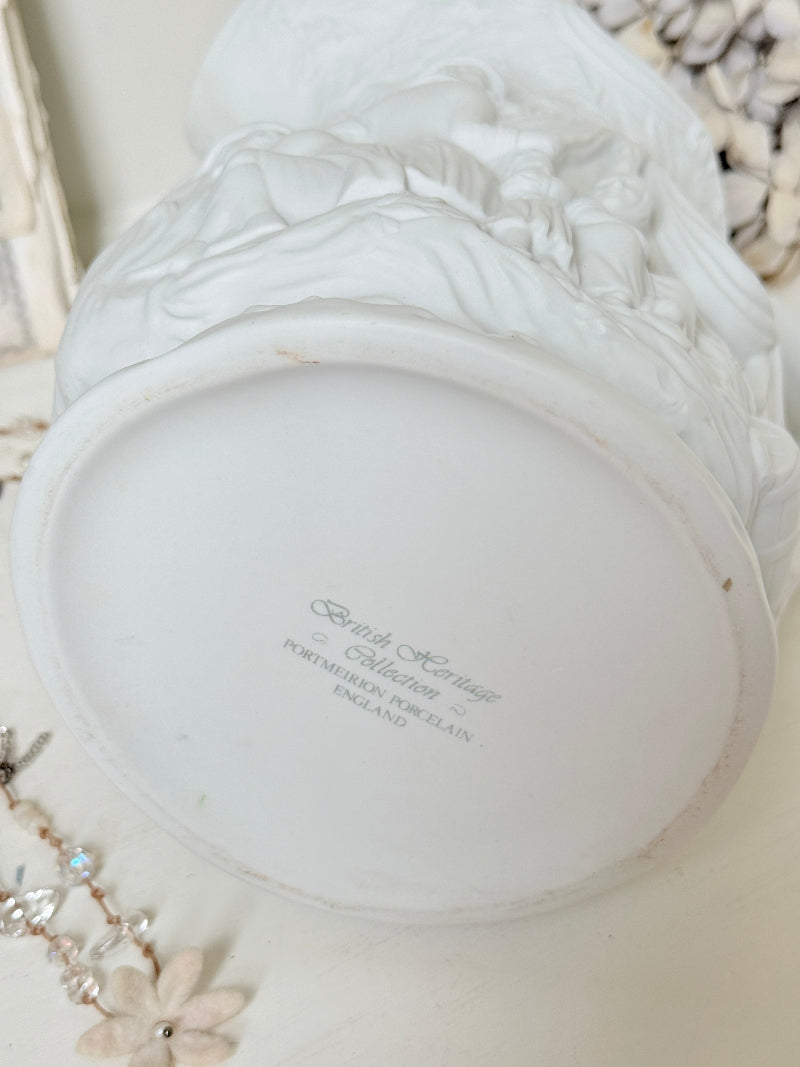 A close-up of the bottom of a white ceramic decorative container or planter, showing the printed brand name &