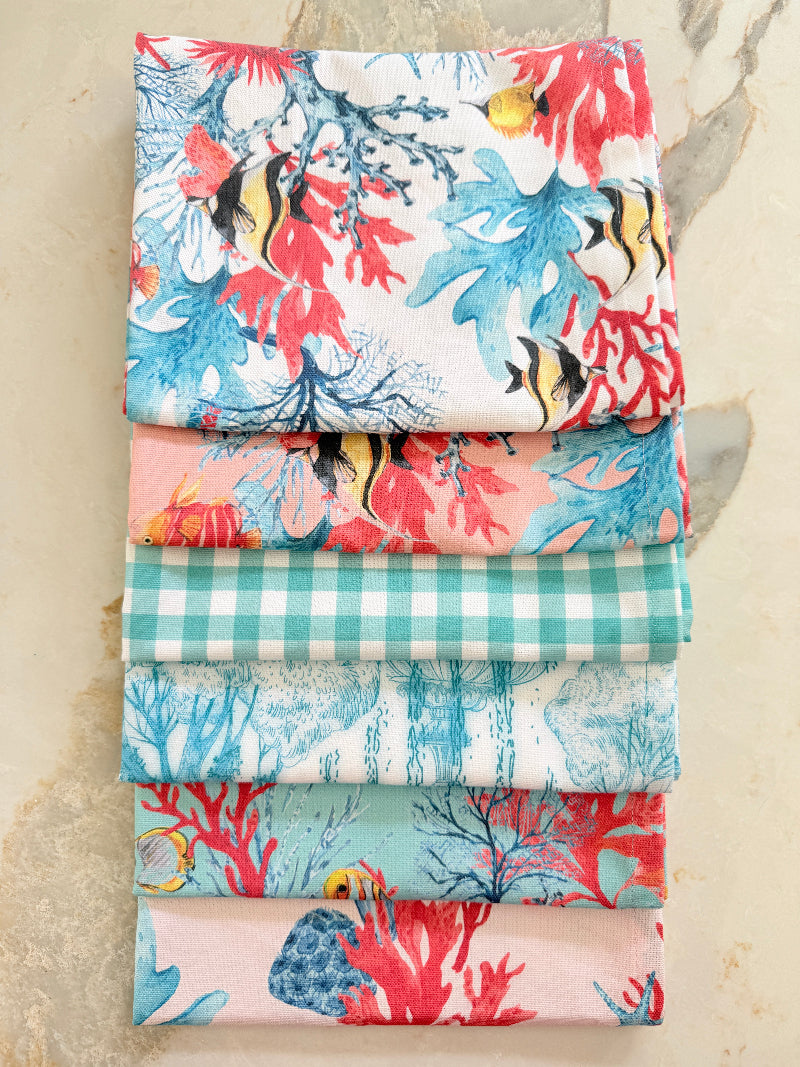 The Blue Loft Caribbean reef print cotton tea towel in turquoise with coral and tropical fish design