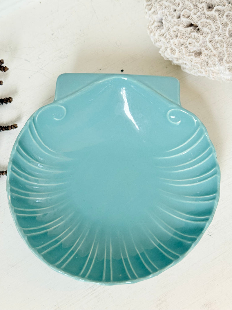 Poole Pottery scallop shell serving dish in sea blue glaze photographed on a white surface