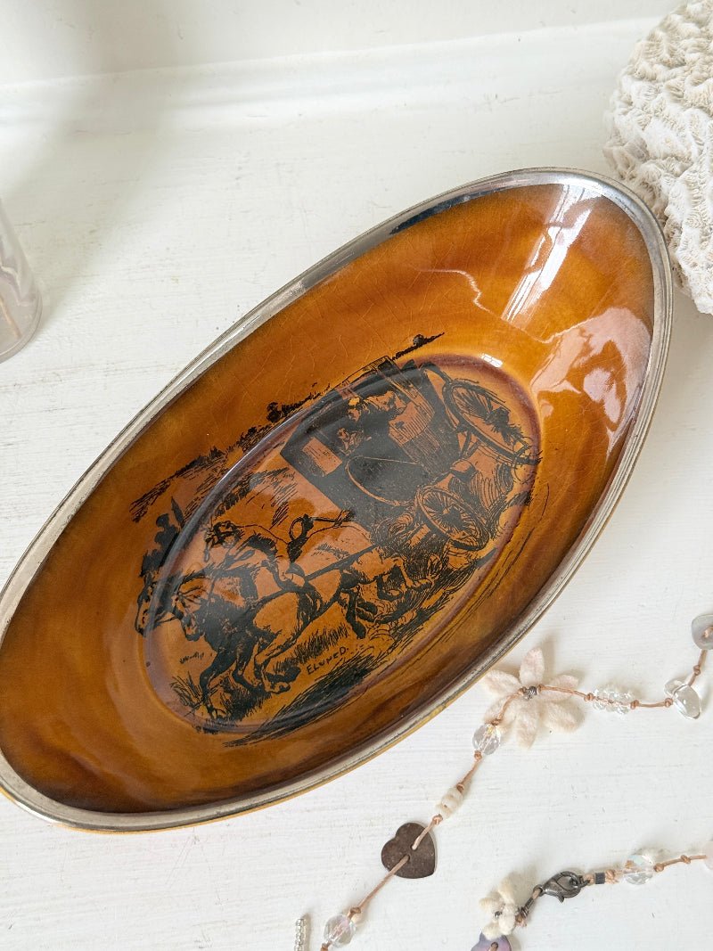 Antique Ridgways stoneware oval dish photographed on a white surface in amber treacle glaze with black Coaching Days and Coaching Ways transfer scene