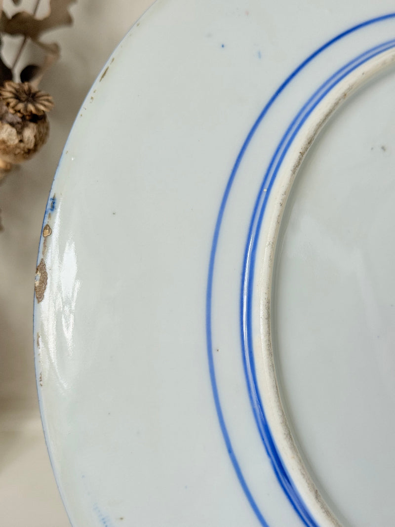 Antique Japanese Aoki Brothers platter with colourful Imari style floral pattern photographed on a white surface
