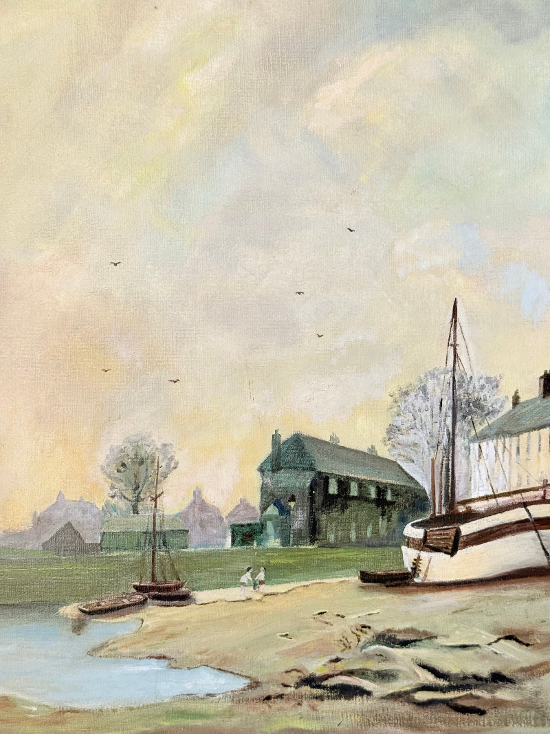 Vintage oil painting on board of a rural village scene with houses, trees, and water, photographed on a white surface
