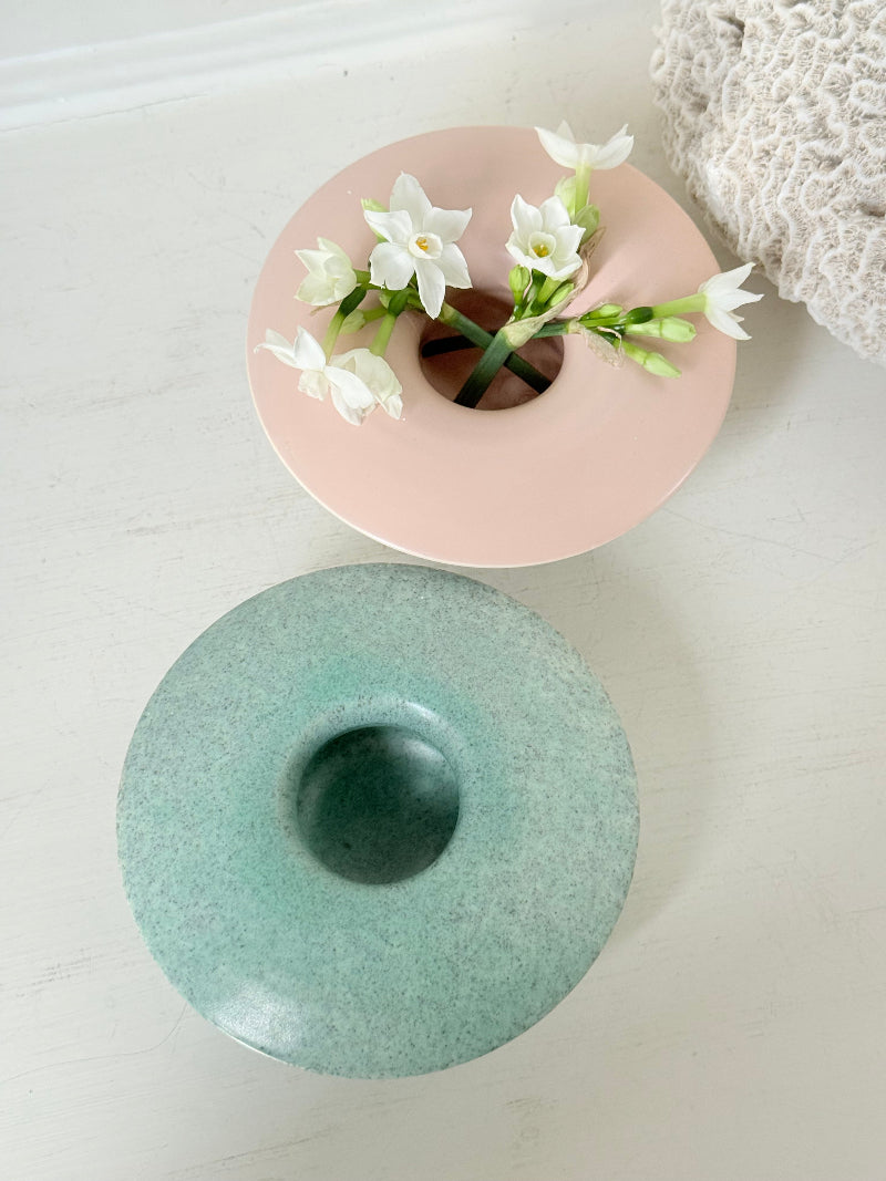 Pair of Poole Pottery mushroom posy vases in seafoam green and blush pink glazes photographed on a white surface