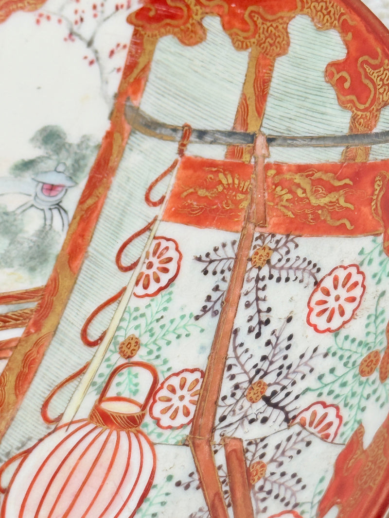 Japanese Kutani porcelain dish hand painted with a garden pavilion scene in iron red and gold