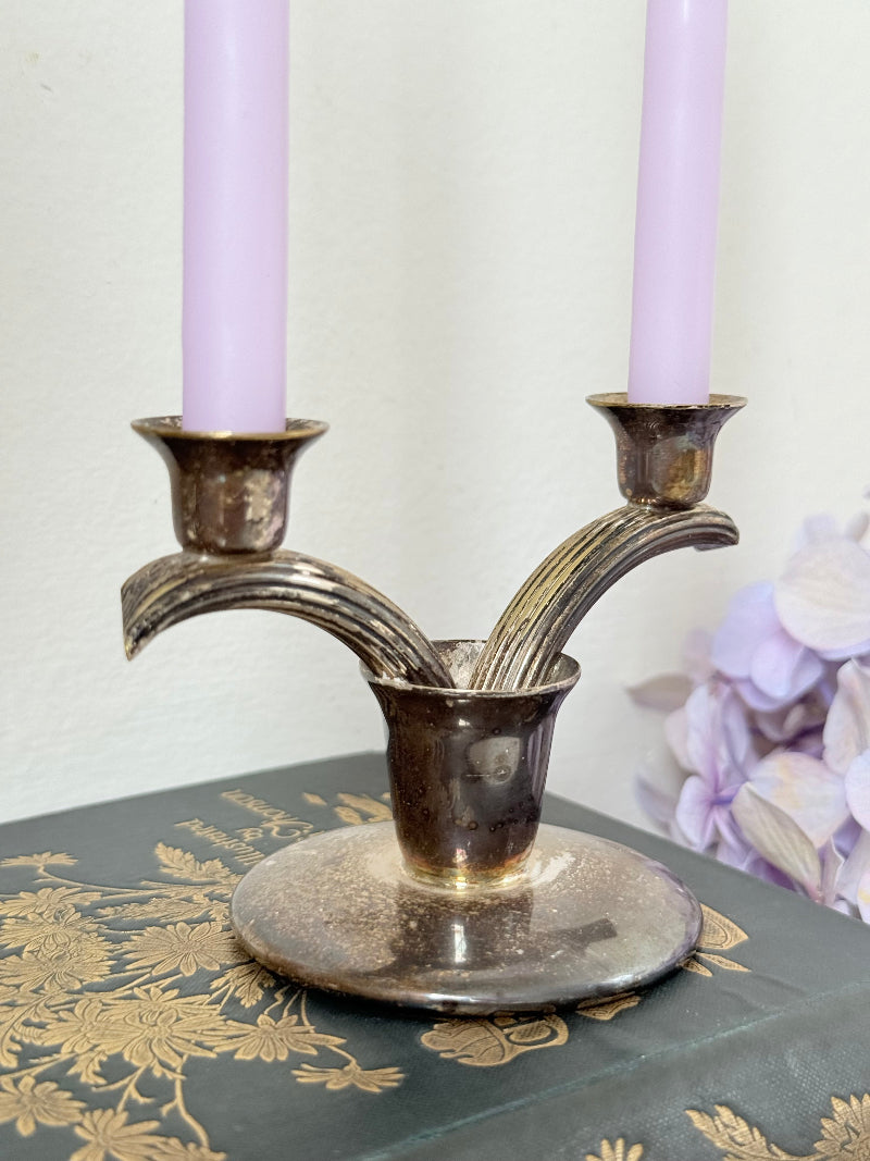 Vintage miniature silver plate candlestick with twin holders, photographed on white surface