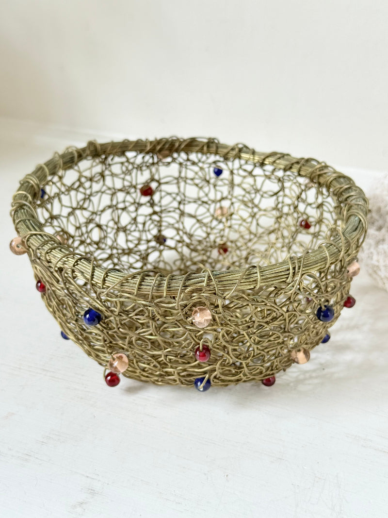 Vintage brass wire basket with coloured glass beads, photographed from multiple angles on a white surface