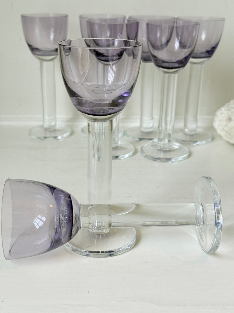 Set of 8 vintage lilac tinted liqueur glasses on a white surface