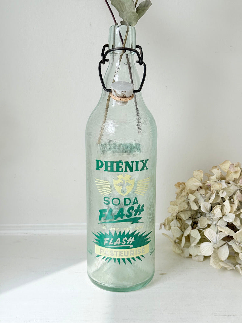 vintage french soda bottle phenix aqua green glass with ceramic swing top 31cm on white surface