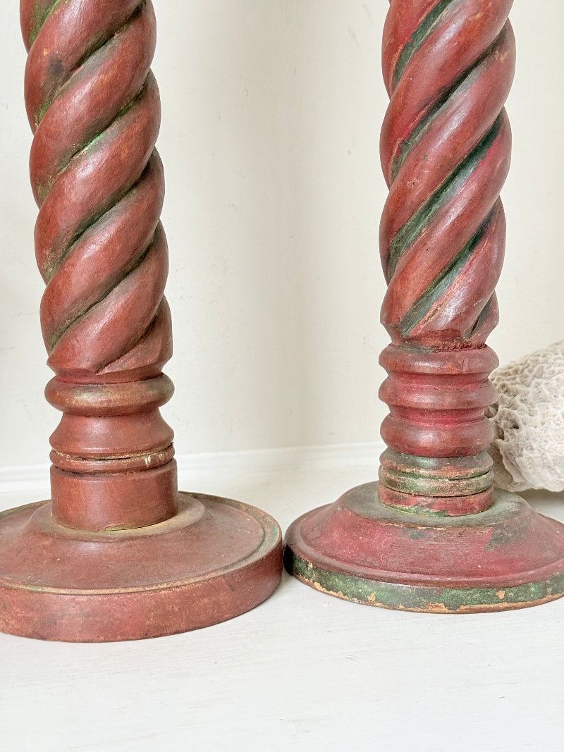 Vintage wooden barley twist candlesticks, a pair with painted finish, photographed on a white surface