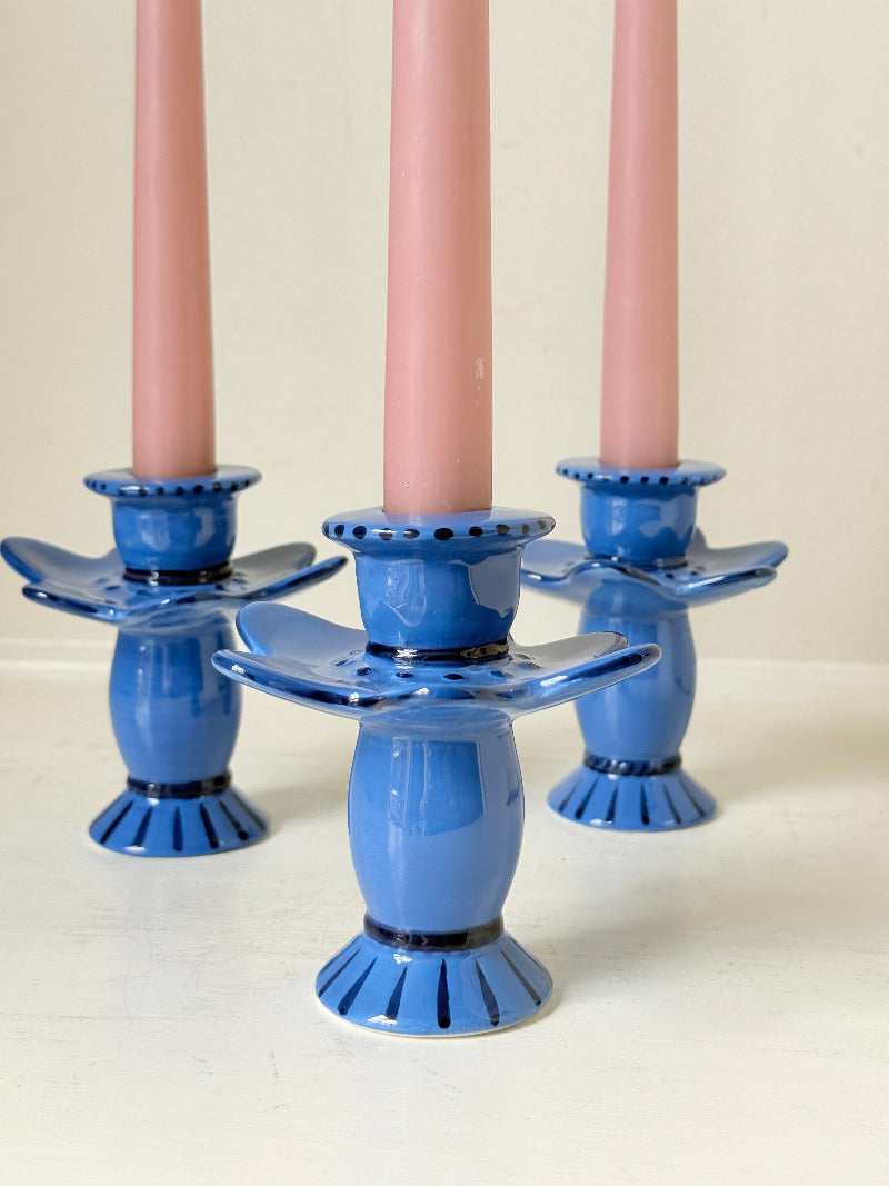 Trio of &Klevering Amsterdam cobalt blue ceramic candle holders with hand painted detail and pink taper candles