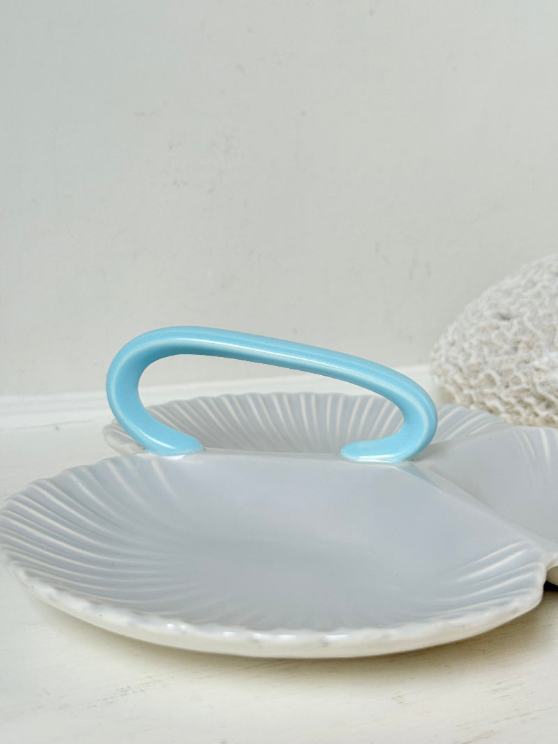 Poole Pottery triple scallop hors d’oeuvre dish in grey glaze with powder blue handle photographed on a white surface
