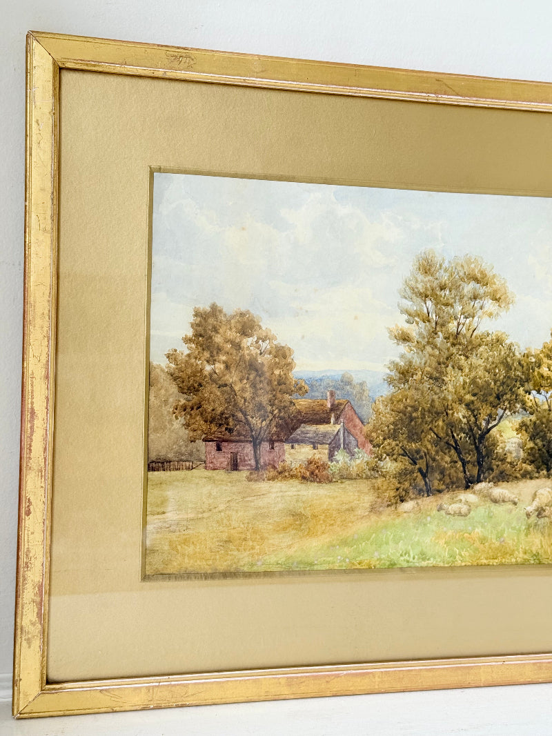 Antique watercolour landscape in gilt frame, countryside scene with trees, photographed on white surface.