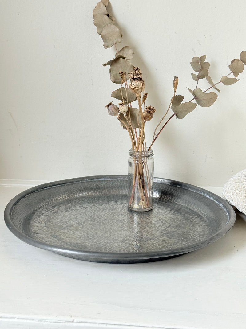 Vintage Harrods pewter drinks tray with hammered surface photographed on a white background.