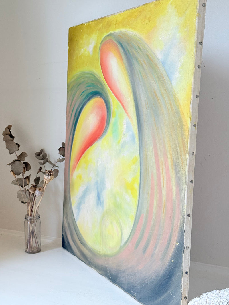 Abstract oil painting on canvas in yellow, pink and grey tones, photographed upright on a white surface.