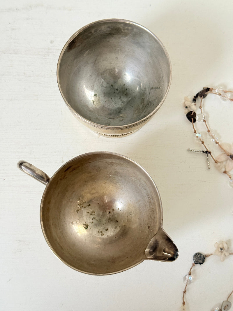 Vintage silver plated on brass sugar bowl and milk jug set, photographed on a white surface