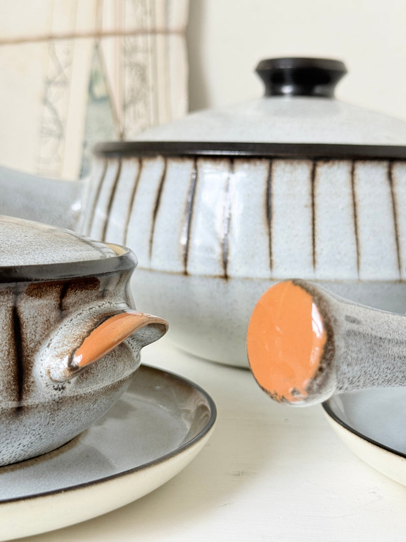Denby Studio stoneware casserole and soup bowl set in grey and rust photographed on a white surface