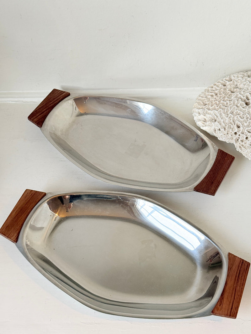 Pair of mid century stainless steel and teak crudites dishes photographed on a white surface