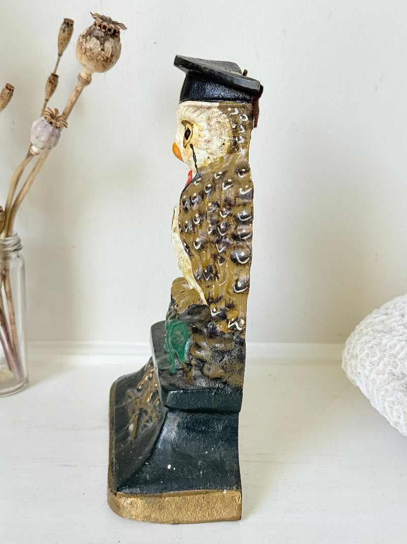 vintage hand painted cast iron owl doorstop with mortarboard and bow tie on white surface