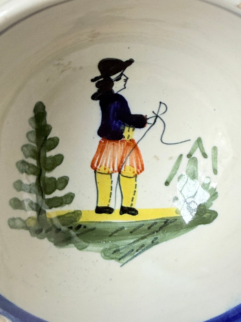 Pair of vintage French Quimper olive bowls with Breton figure and fan handles, photographed on a white surface