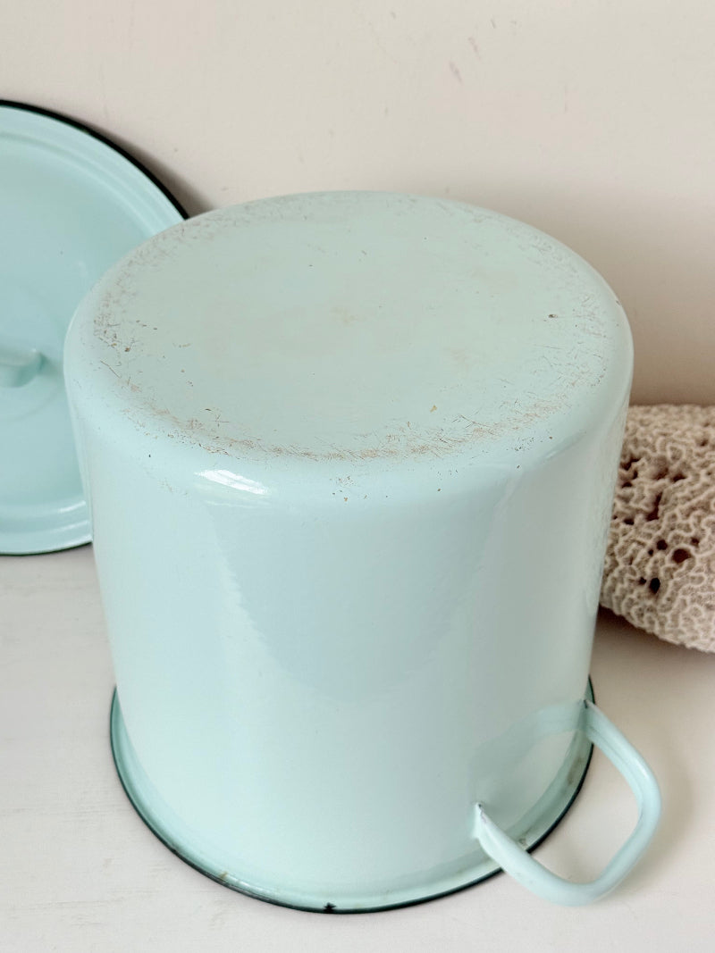 Vintage pale blue enamel bread bin with lid and handles, photographed on a white surface