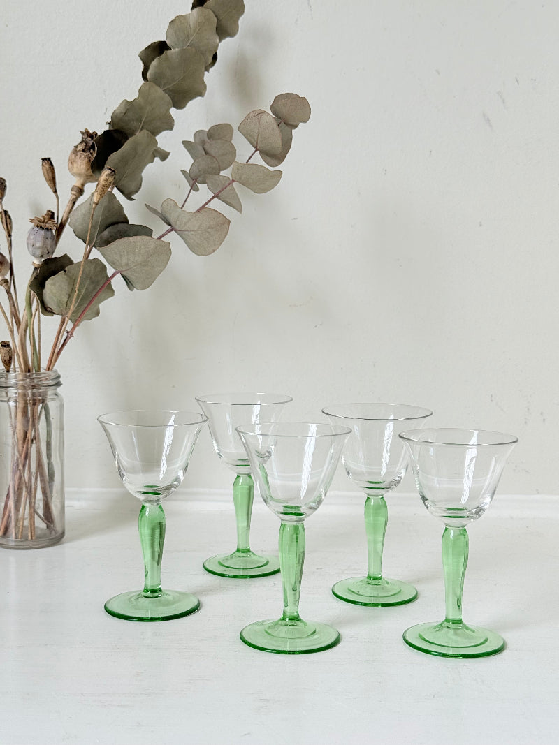Set of five green stemmed liqueur glasses