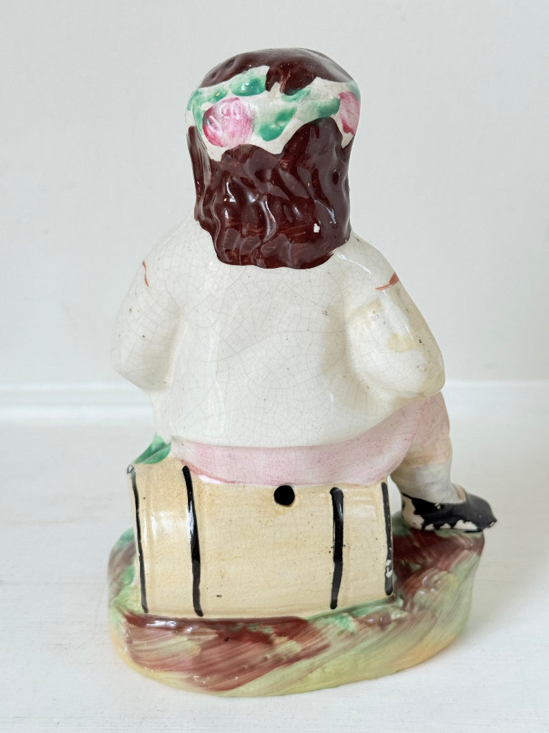 Bacchus antique Staffordshire pottery figure with painted details, photographed on a white surface.