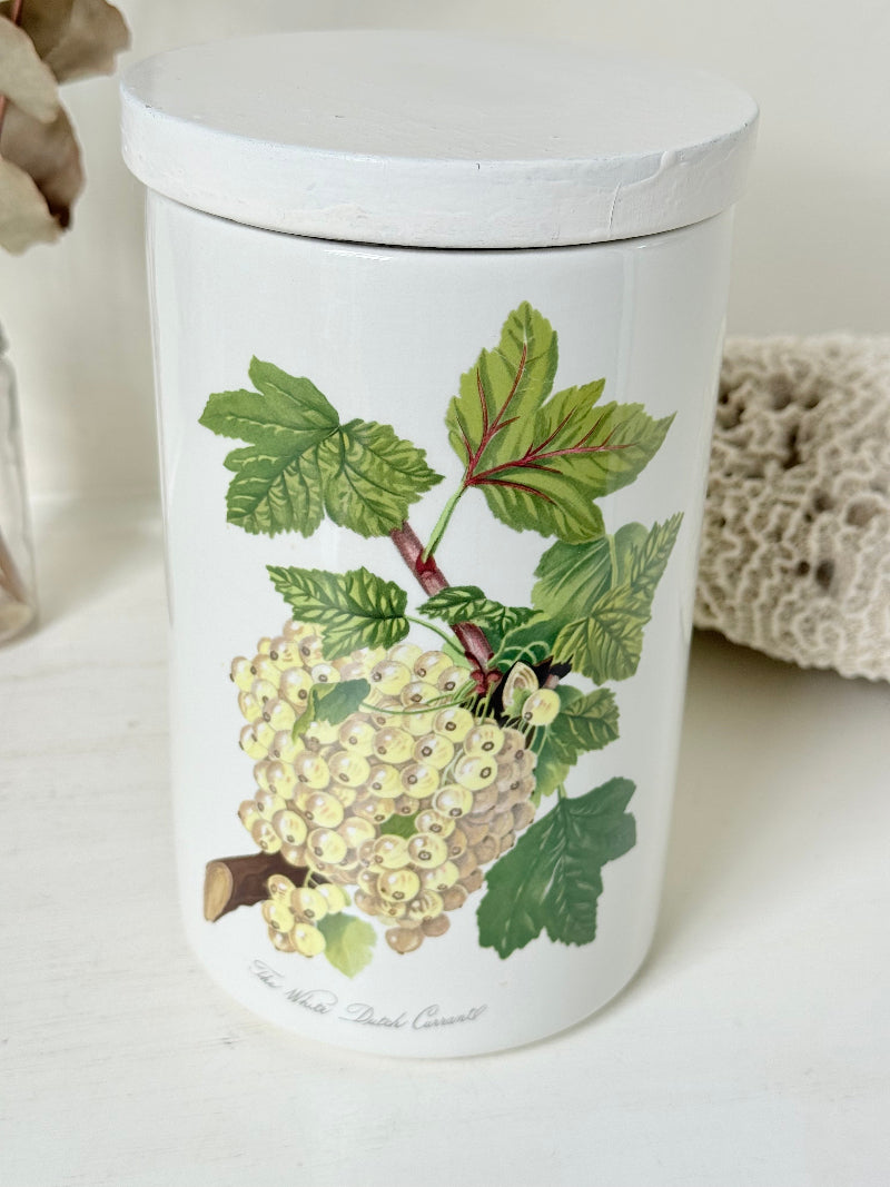 Vintage Portmeirion Botanic Garden ceramic canister with wooden lid and hydrangea design photographed on a white surface.