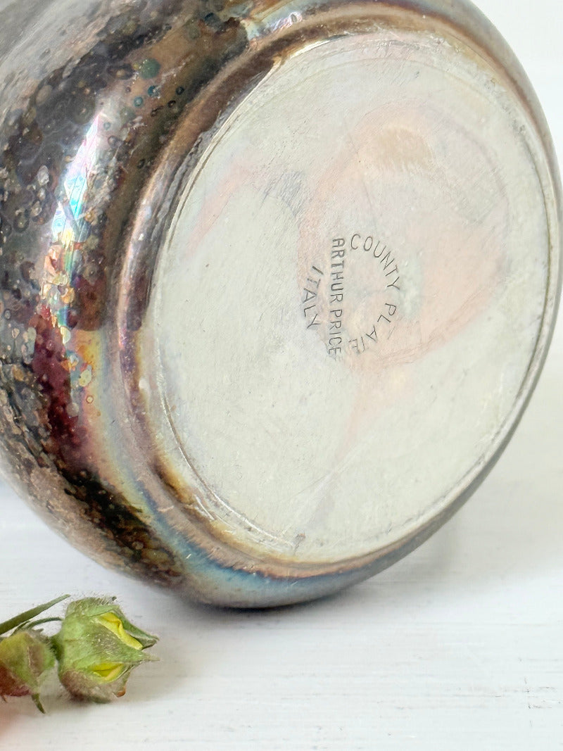 vintage silver plate beaker by arthur price with ornate handle and patina, photographed with red flowers on a white surface
