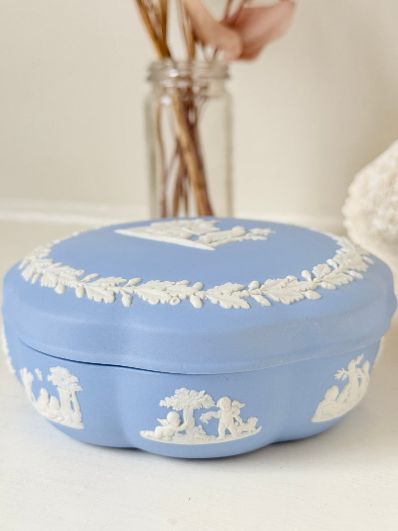 Vintage Wedgwood pale blue Jasperware lidded trinket box with a scalloped base, decorated with a white neoclassical cameo and laurel wreath border.