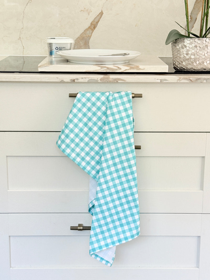 Blue Loft cotton tea towel duo with turquoise gingham check and blue toile pattern photographed in a kitchen setting.
