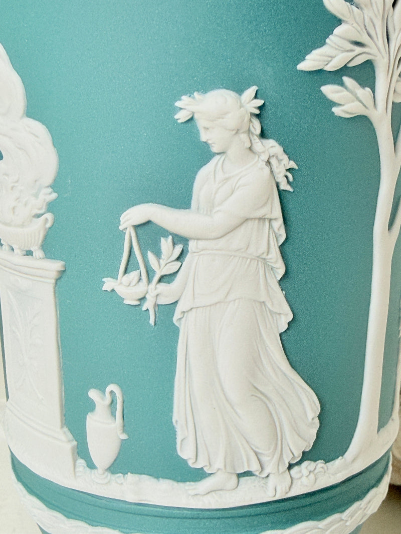 Large vintage Wedgwood Jasperware teal green pedestal vase decorated with white classical Muses figures and stylised trees, styled with dried stems.