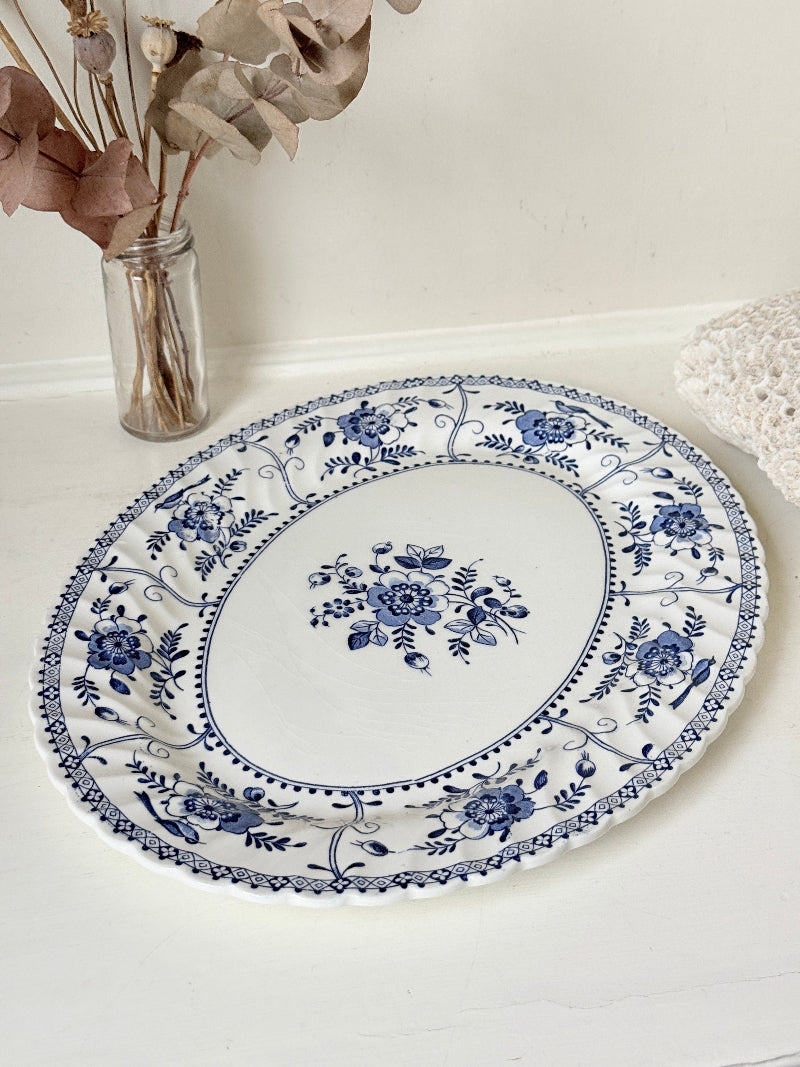 Vintage Johnson Brothers Indies blue and white oval serving platter photographed on a white surface