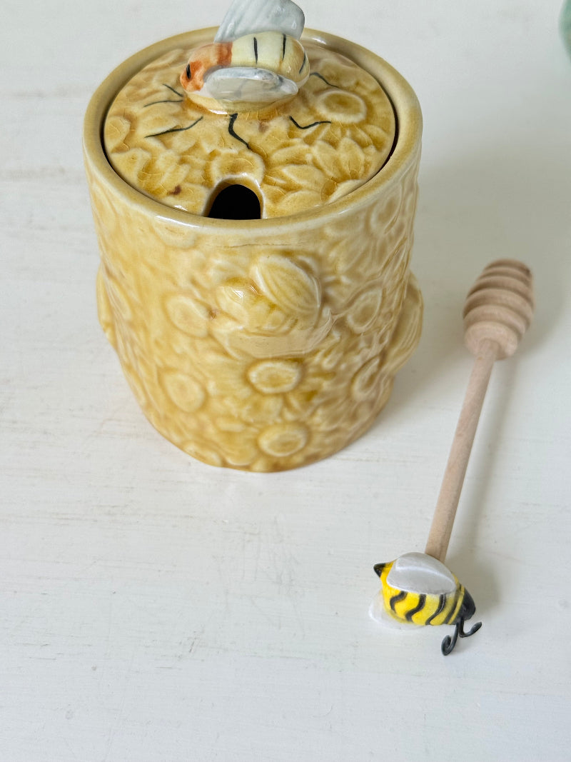 Secla pottery honey jar with lid, bee motif, and wooden honey spoon, made in Portugal, photographed on a white surface