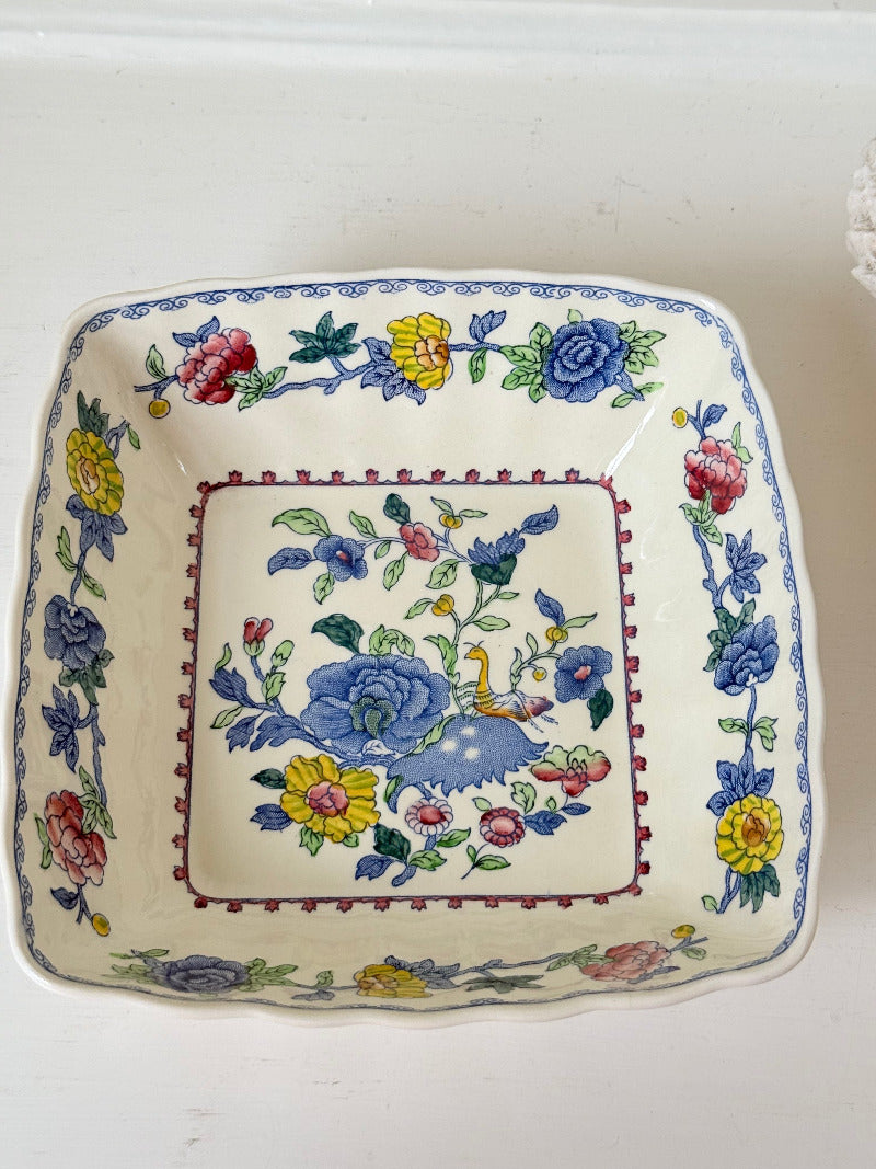 Vintage Mason’s ironstone serving dish with square form and spring floral pattern in blue, pink, yellow, and green, photographed on a white surface