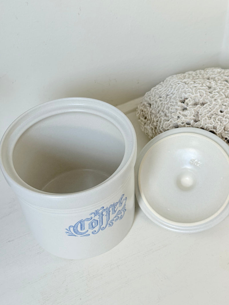 Pfaltzgraff Yorktowne stoneware coffee jar with blue floral motif and lid, photographed on a white surface