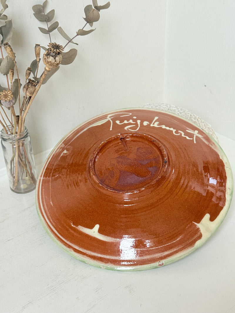 Puidgemont Spanish studio pottery plate with hand painted fish and coral design in green, turquoise, and terracotta tones, photographed on a white surface.