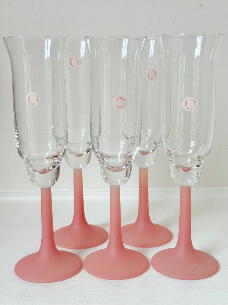 Set of five 1980s frosted pink tulip champagne flutes from the Candlelight range, photographed on a white surface