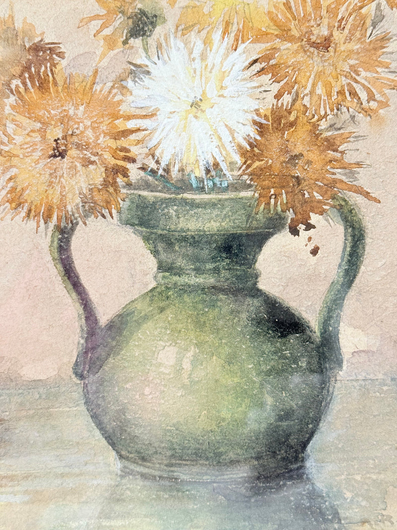 Vintage watercolour of chrysanthemums in green vase, under glass, in cream faux bamboo frame, photographed on white surface.