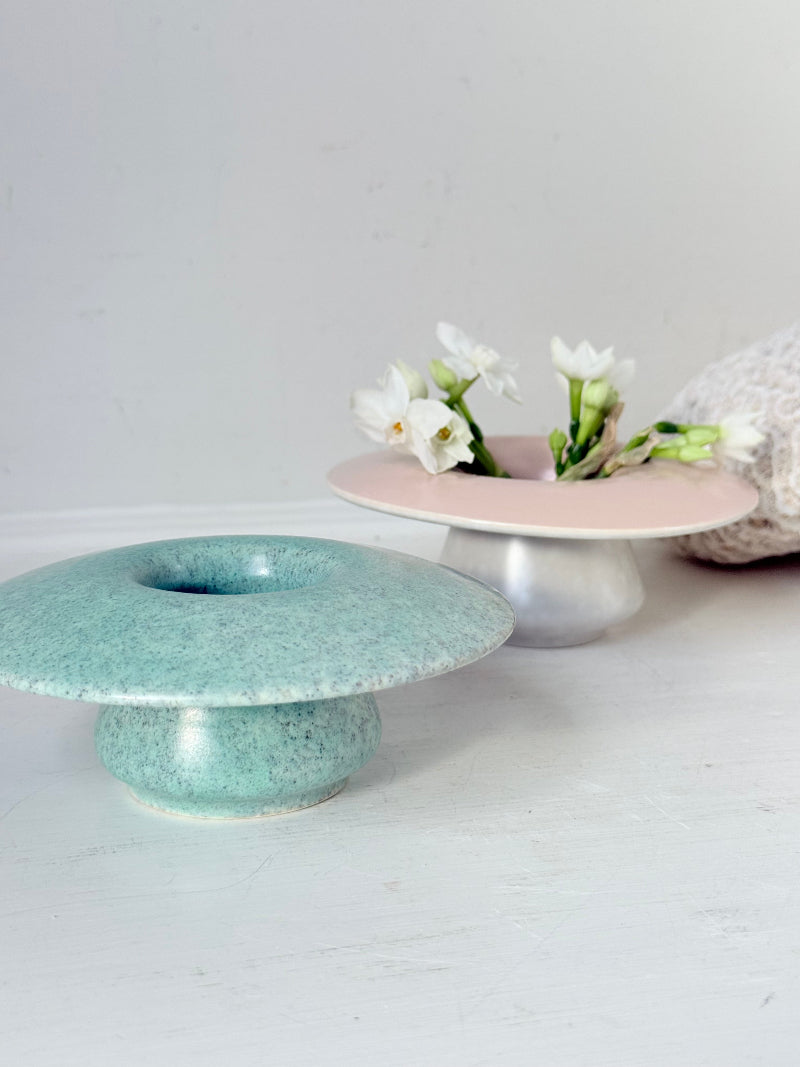 Pair of Poole Pottery mushroom posy vases in seafoam green and blush pink glazes photographed on a white surface