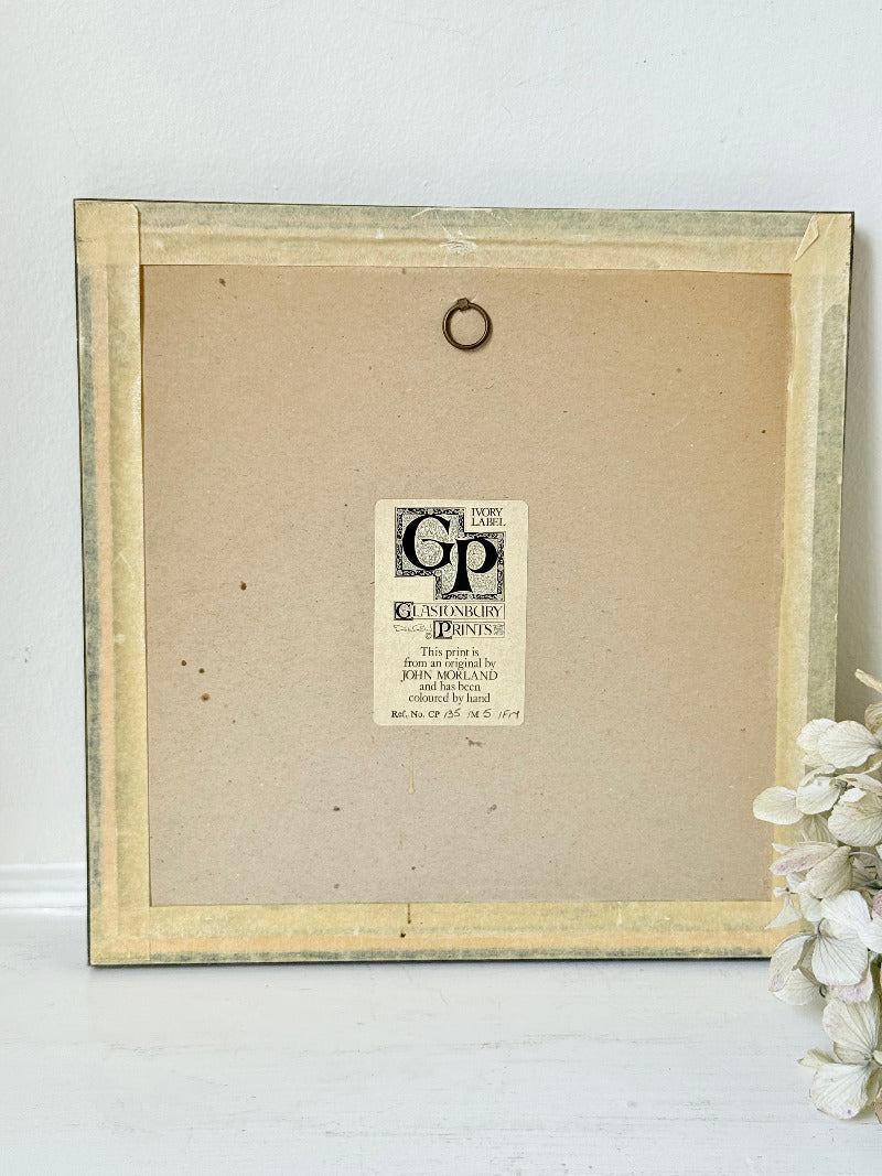 framed hand coloured botanical print of ivy and white blossoms photographed on white surface