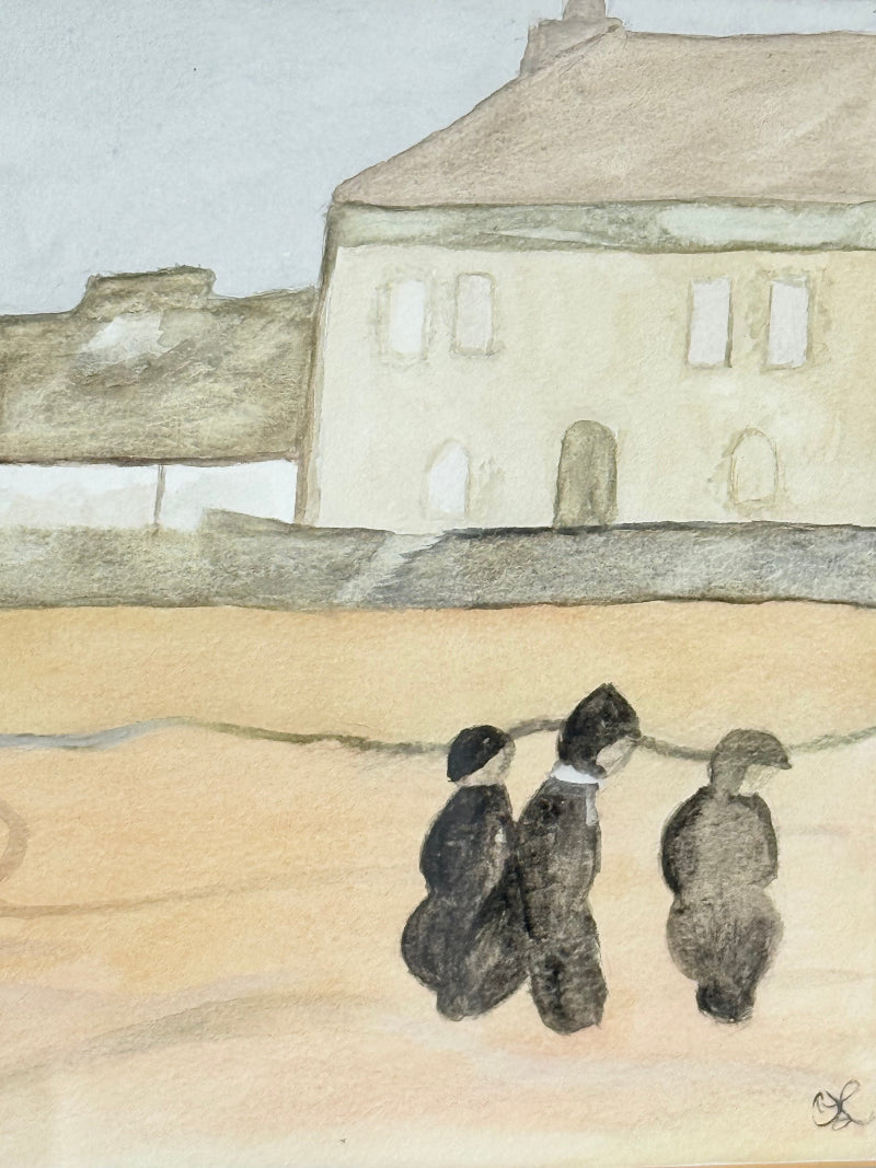Framed neutral-toned village scene watercolour with figures in light oak-effect frame and pale grey mount, on white surface.